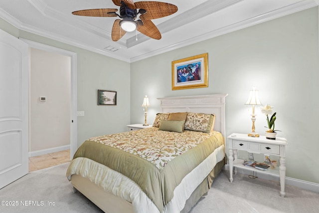 bedroom featuring baseboards, a ceiling fan, light colored carpet, a tray ceiling, and crown molding