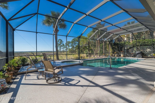 view of pool featuring a lanai, a patio area, and a pool with connected hot tub