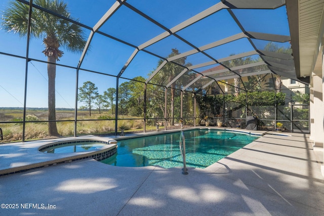 view of pool featuring a lanai, a patio area, and a pool with connected hot tub