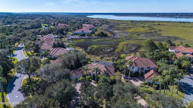 drone / aerial view with a residential view and a water view