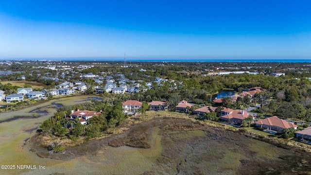 drone / aerial view with a water view and a residential view