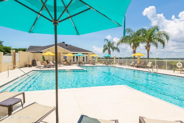 pool featuring a patio and fence