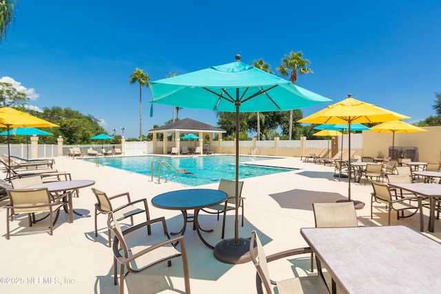 pool featuring a patio area, fence, and a gazebo