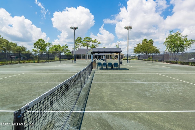 view of sport court featuring fence