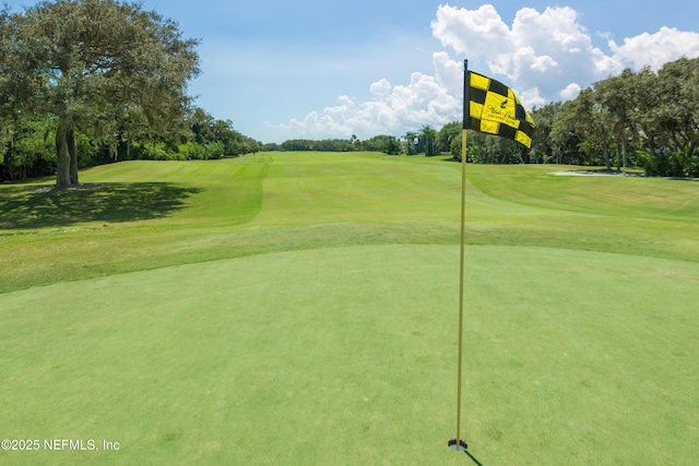 view of property's community featuring a yard and golf course view