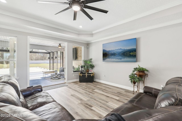 living area with crown molding, recessed lighting, ceiling fan, wood finished floors, and baseboards