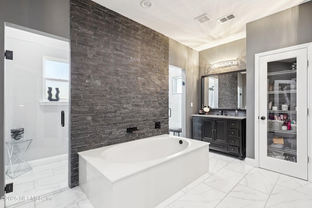 full bathroom with visible vents, marble finish floor, a textured ceiling, vanity, and a bath