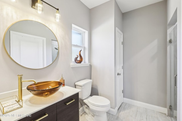 bathroom featuring marble finish floor, baseboards, vanity, and toilet