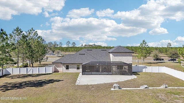 rear view of property with a patio area, a fenced backyard, glass enclosure, and a lawn