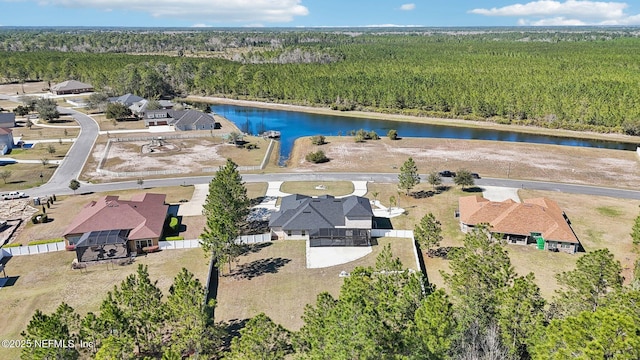 birds eye view of property with a water view and a forest view