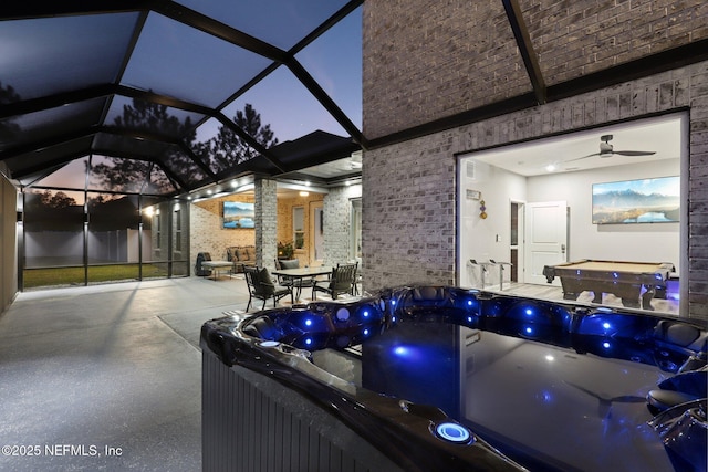 view of patio featuring a lanai