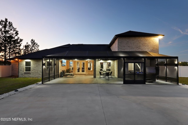 back of property featuring brick siding, a patio, and fence