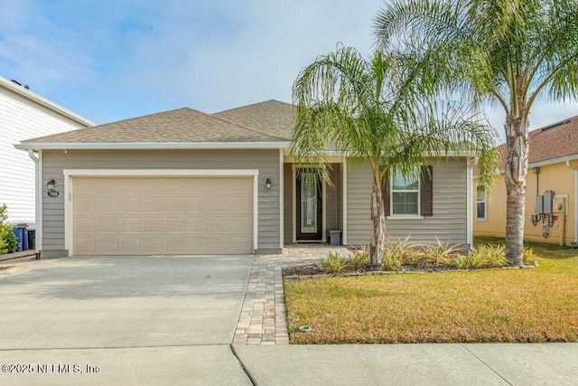 ranch-style home with a garage and a front lawn