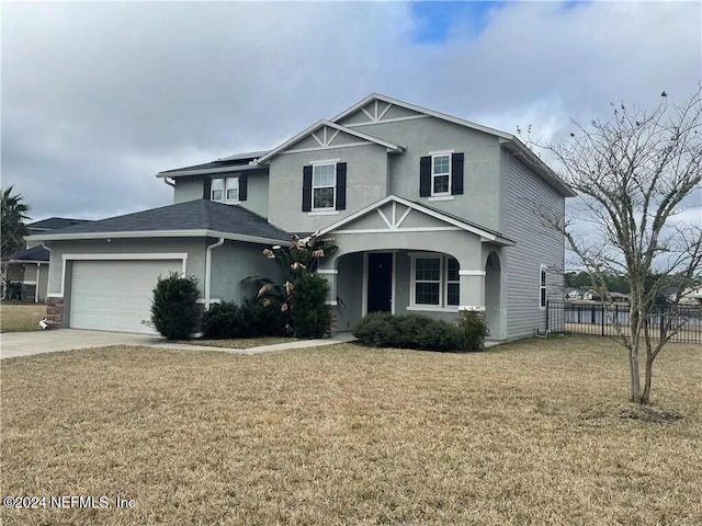 view of property with a garage and a front yard