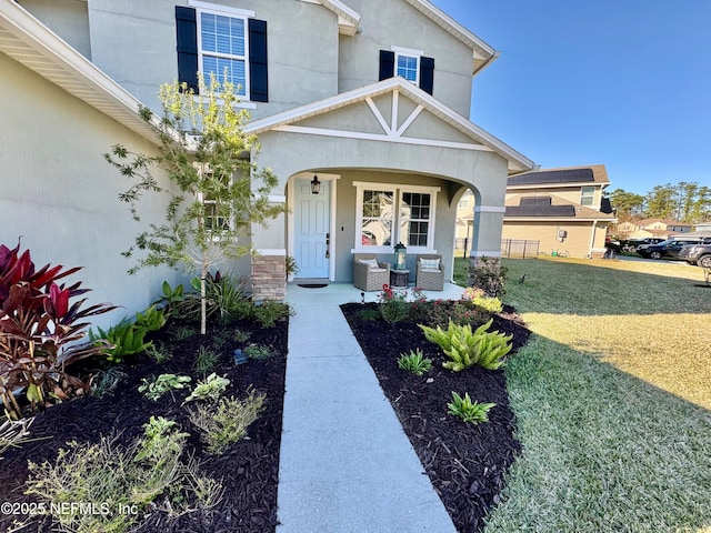 doorway to property featuring a yard