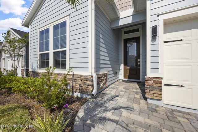 doorway to property featuring a garage