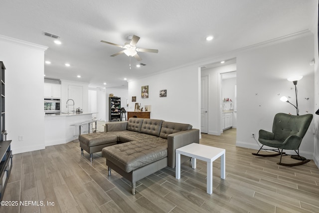 living room featuring crown molding and ceiling fan