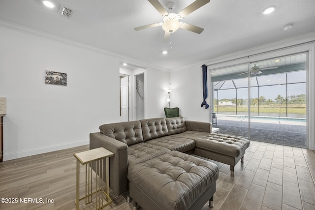 living room featuring light hardwood / wood-style flooring, ornamental molding, and ceiling fan