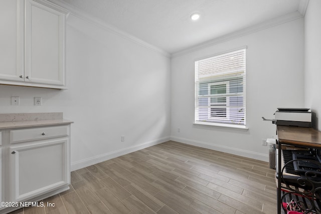 interior space featuring crown molding and light hardwood / wood-style flooring