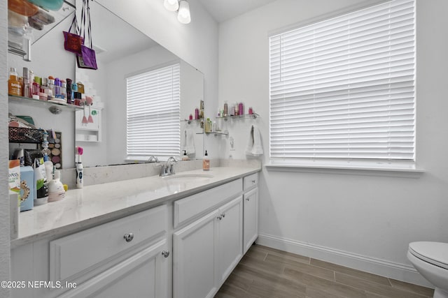 bathroom featuring vanity and toilet