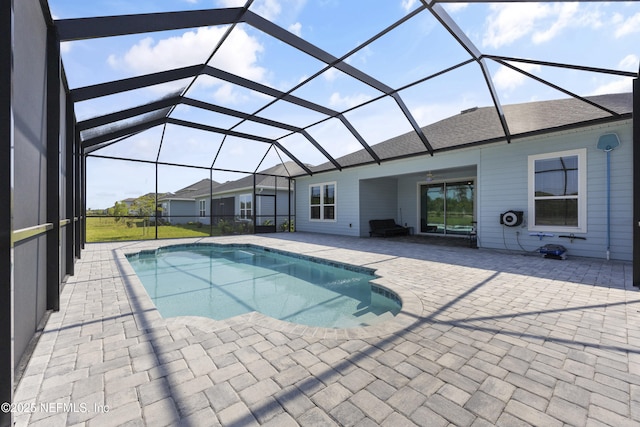 view of swimming pool with a patio area and glass enclosure