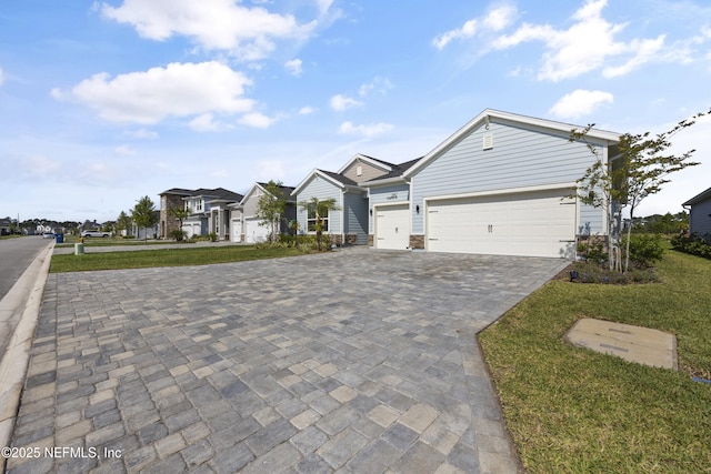 ranch-style house featuring a garage and a front lawn