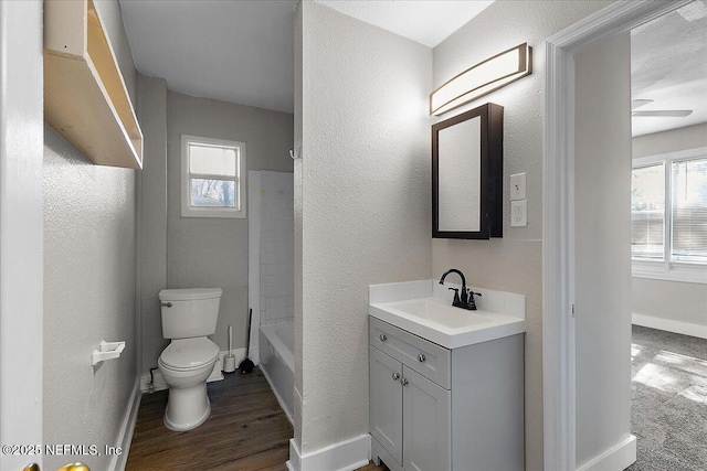 full bathroom with vanity, wood-type flooring, plenty of natural light, and toilet