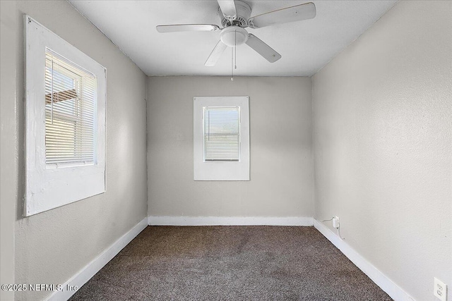 carpeted empty room with a wealth of natural light and ceiling fan