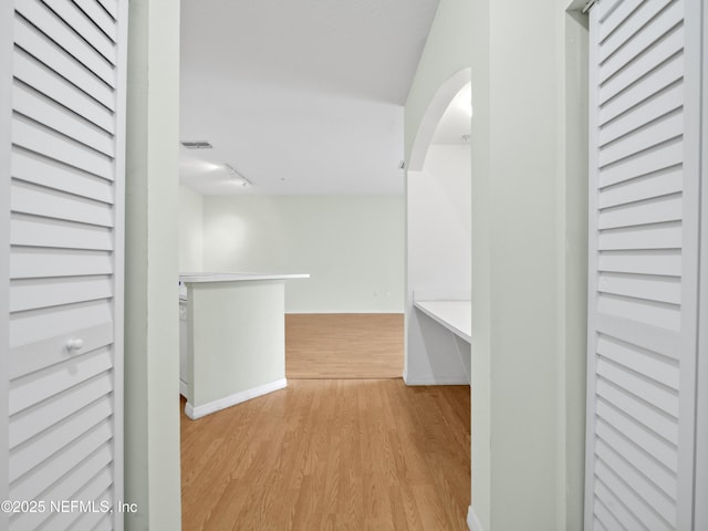 hallway with light hardwood / wood-style floors