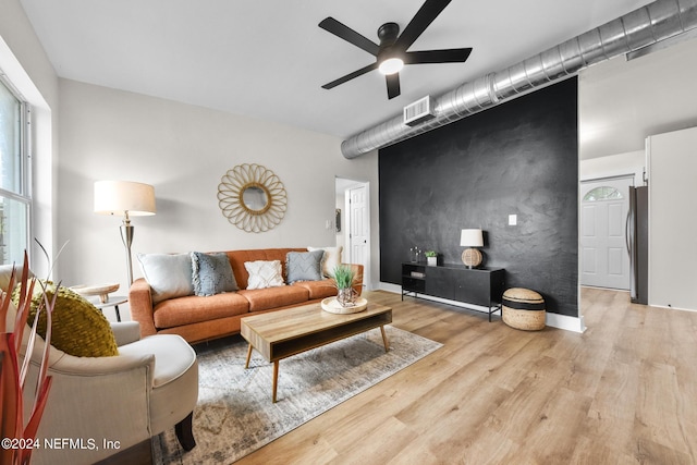 living room featuring light hardwood / wood-style floors and ceiling fan