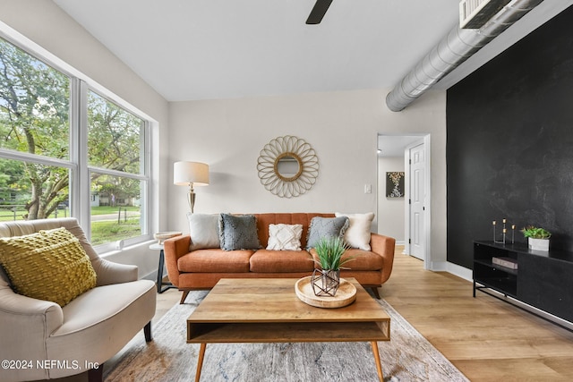 living room featuring ceiling fan and light wood-type flooring