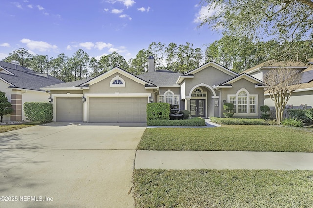 ranch-style home featuring a garage, driveway, stucco siding, a chimney, and a front yard