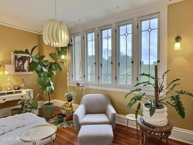 sitting room featuring ornamental molding and hardwood / wood-style floors