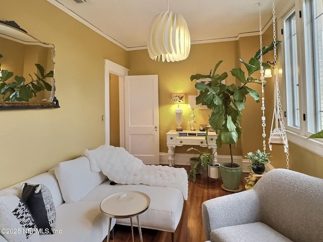 living room featuring ornamental molding and wood-type flooring