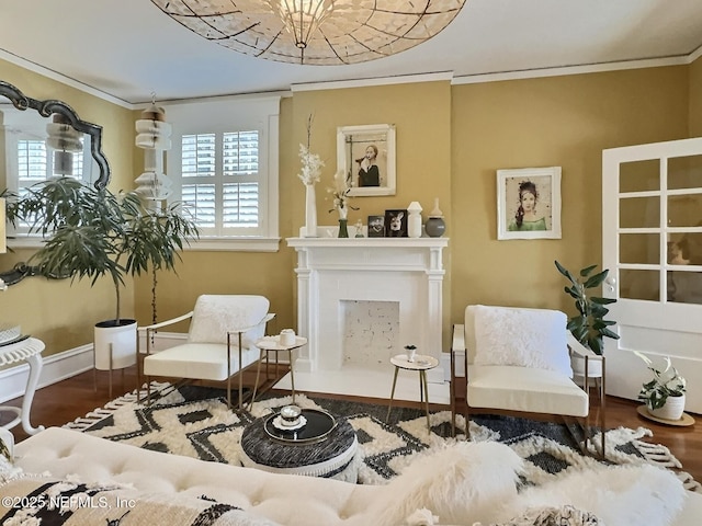 sitting room with hardwood / wood-style flooring and ornamental molding