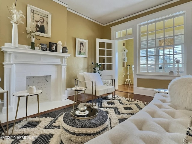 sitting room featuring crown molding and hardwood / wood-style flooring