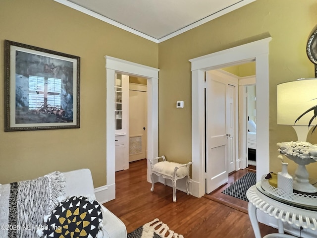 living area featuring ornamental molding and dark hardwood / wood-style flooring