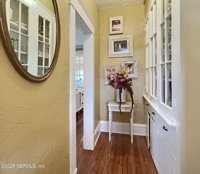 hallway with dark hardwood / wood-style flooring