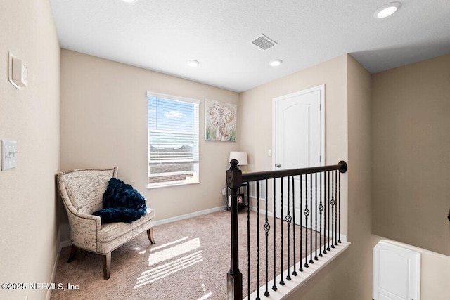 hallway with light colored carpet