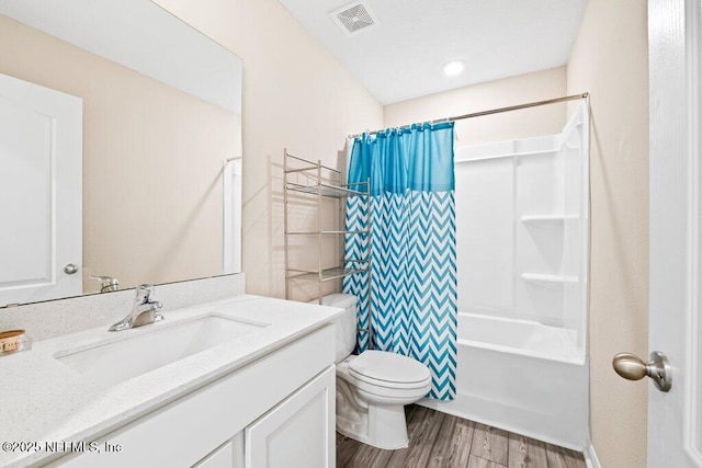 full bathroom featuring vanity, toilet, hardwood / wood-style floors, and shower / bath combo with shower curtain