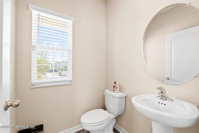 bathroom featuring toilet and sink