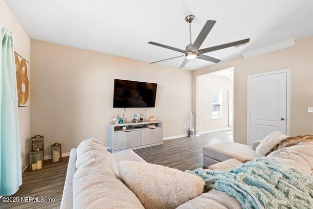 living room with dark wood-type flooring and ceiling fan