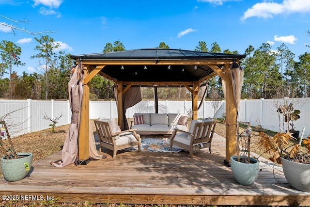 wooden deck featuring a gazebo and an outdoor hangout area