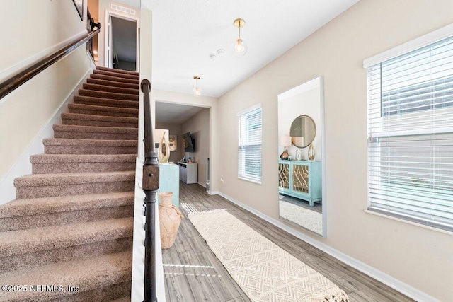 stairway with hardwood / wood-style floors