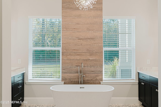 1351 Weaver Glen Rd, Jacksonville, FL 32223 - bathroom with a freestanding tub, vanity, and baseboards