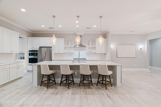 1351 Weaver Glen Rd, Jacksonville, FL 32223 - kitchen with stainless steel appliances, white cabinets, a center island with sink, and hanging light fixtures
