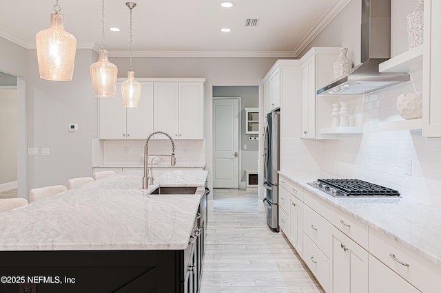 1351 Weaver Glen Rd, Jacksonville, FL 32223 - kitchen featuring decorative light fixtures, white cabinets, wall chimney range hood, appliances with stainless steel finishes, and a center island with sink