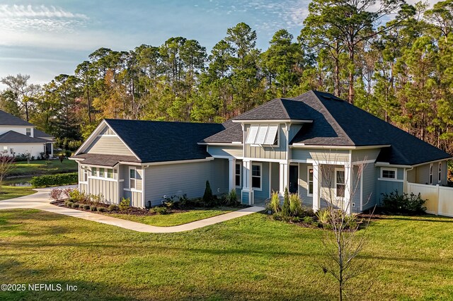 1351 Weaver Glen Rd, Jacksonville, FL 32223 - view of front of home with board and batten siding, fence, and a front lawn