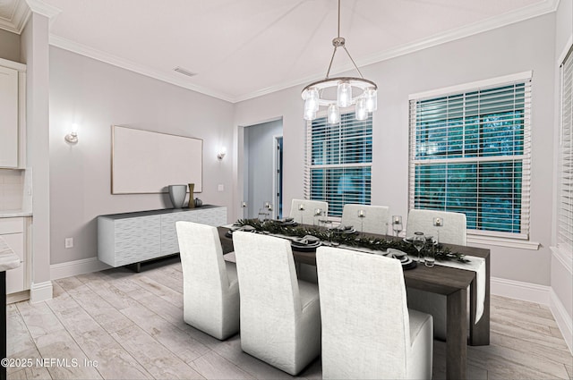 1351 Weaver Glen Rd, Jacksonville, FL 32223 - dining area featuring a chandelier, crown molding, and light wood finished floors