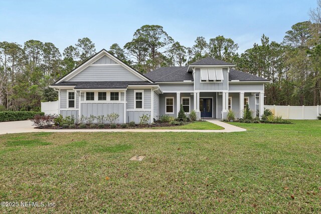 1351 Weaver Glen Rd, Jacksonville, FL 32223 - view of front of property featuring a shingled roof, covered porch, fence, a front lawn, and board and batten siding